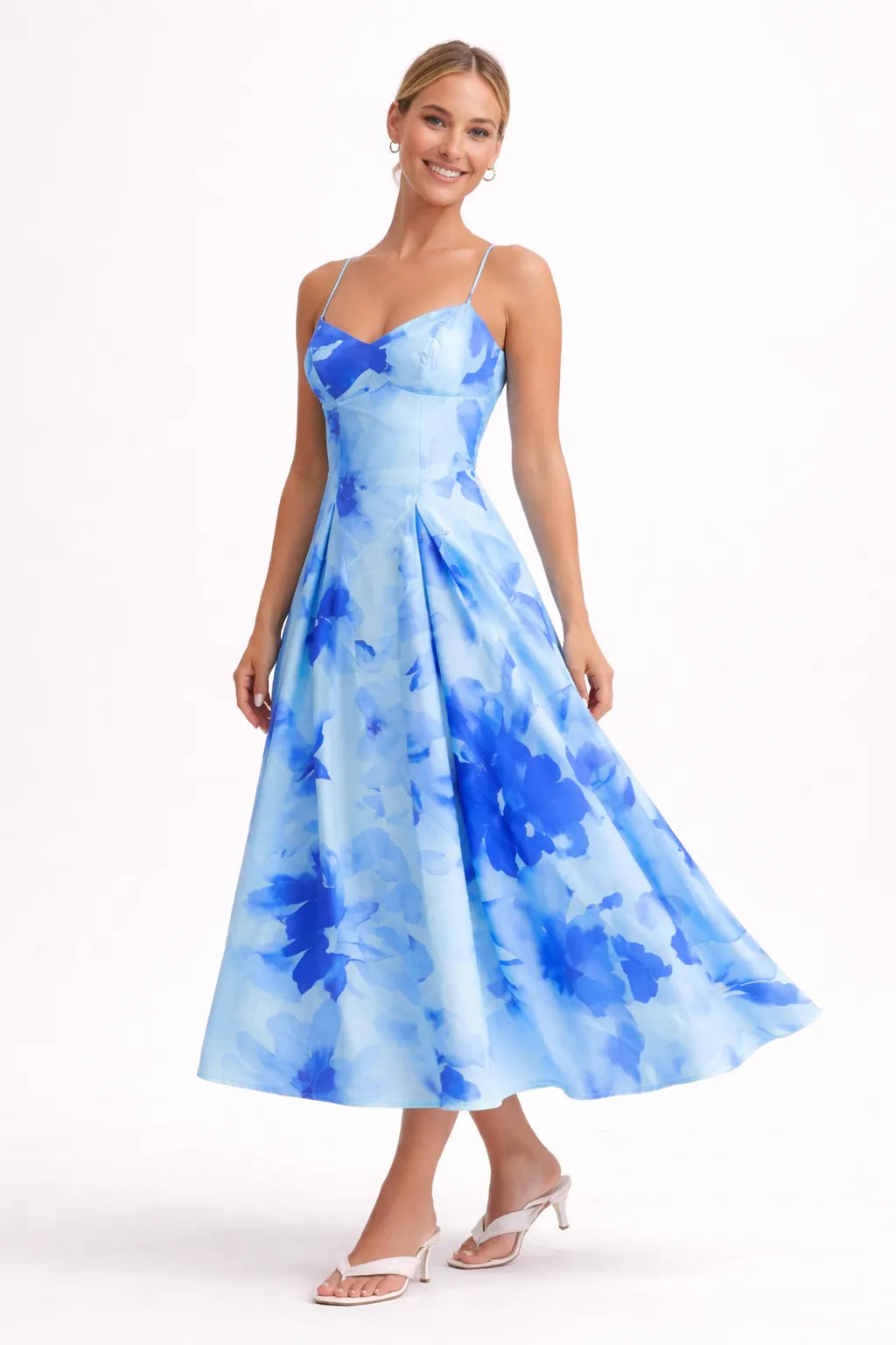 Woman wearing a blue floral dress on a white background