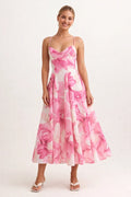Woman wearing a pink floral dress on a white background
