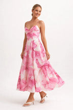 Woman wearing a pink floral dress on a white background