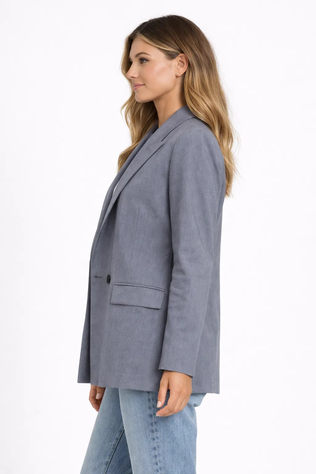 Woman wearing a gray blazer on a white background