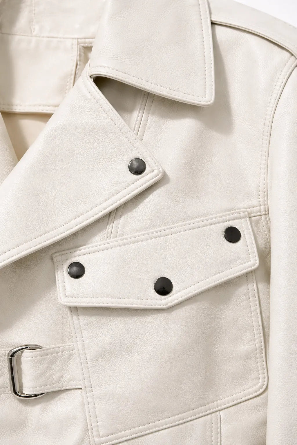 Close-up of a beige trench coat with button details