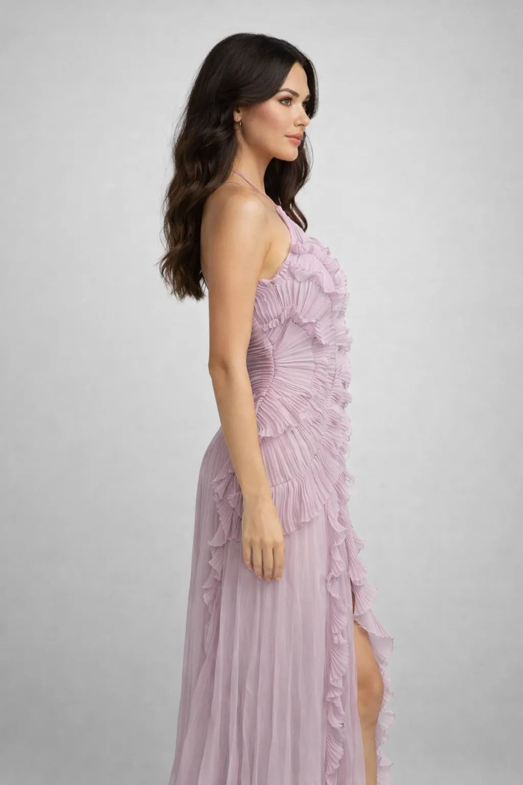 Woman wearing a pink evening gown on a gray background