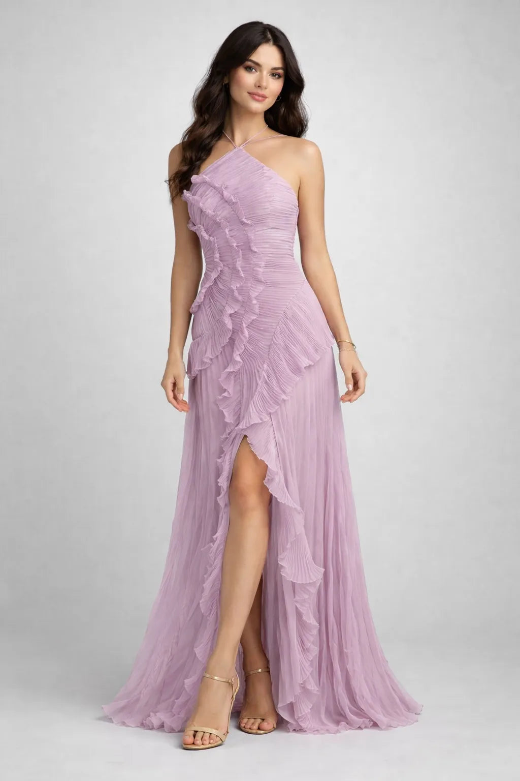 Woman wearing a pink one-shoulder dress with a slit on a gray background