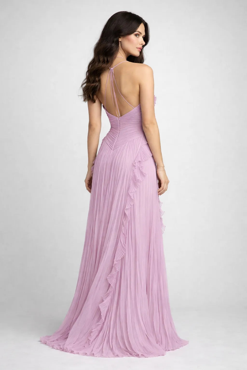 Woman wearing a pink evening gown with a plunging neckline on a white background