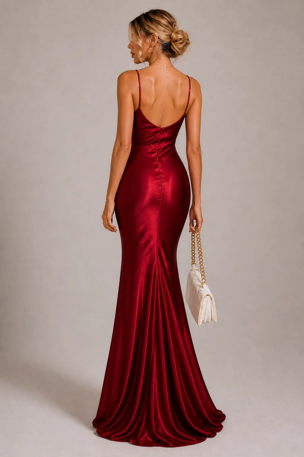 Woman wearing a red evening gown with a plain background