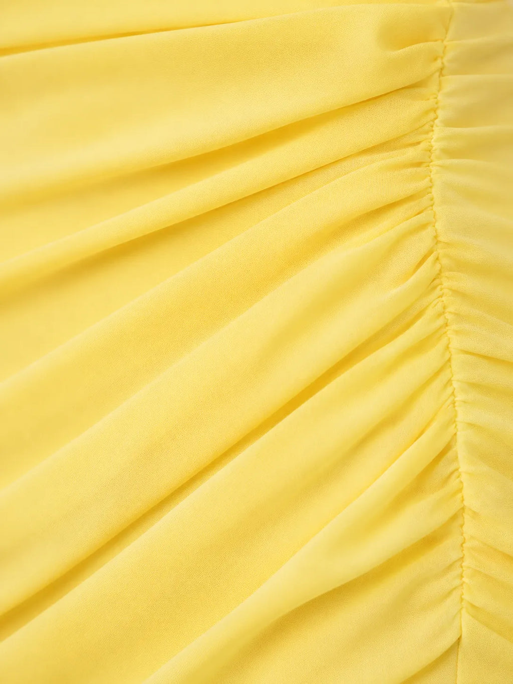Close-up of a yellow fabric with pleated texture