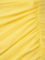 Close-up of a yellow fabric with pleated texture