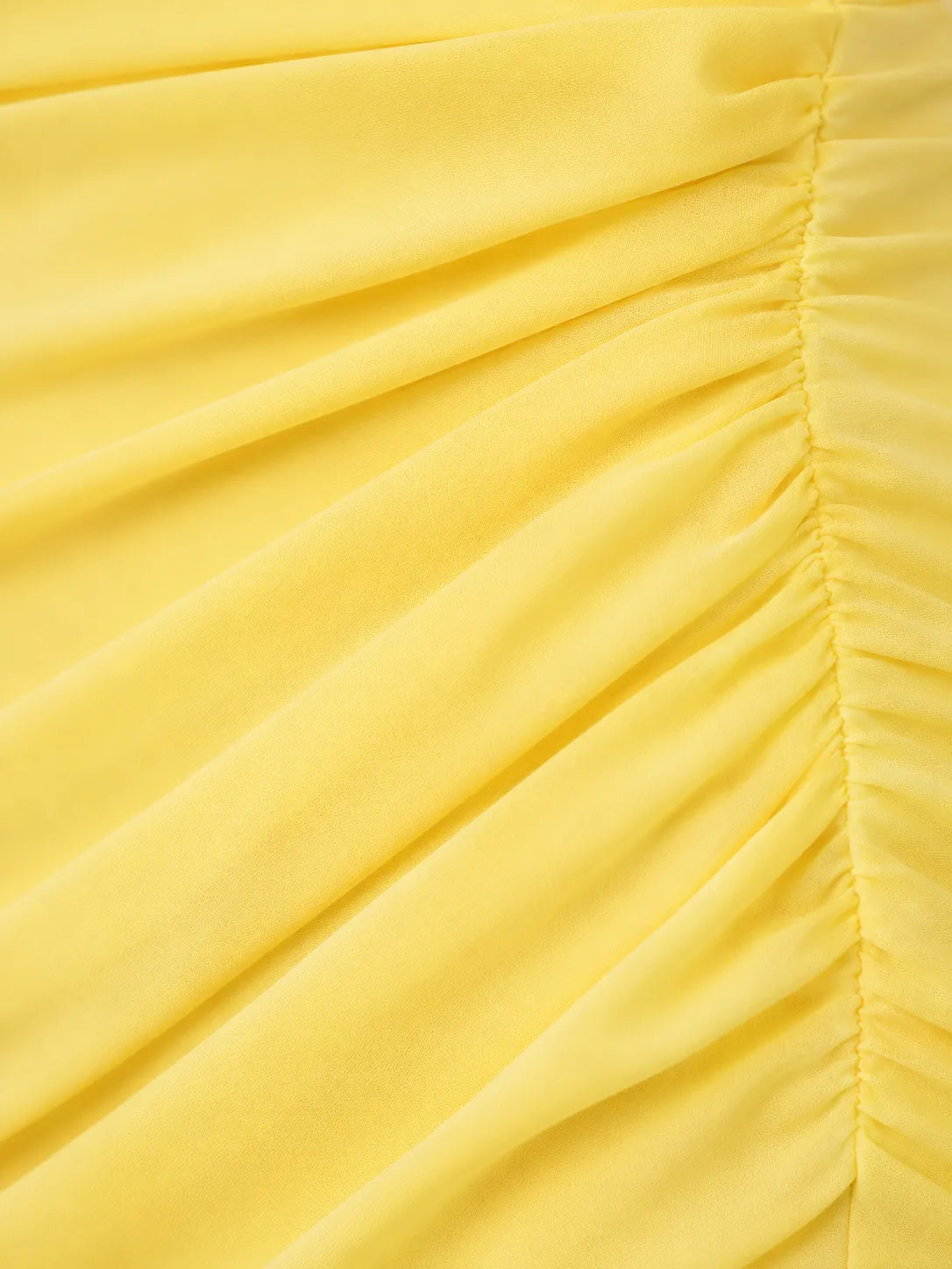 Close-up of a yellow fabric with pleated texture