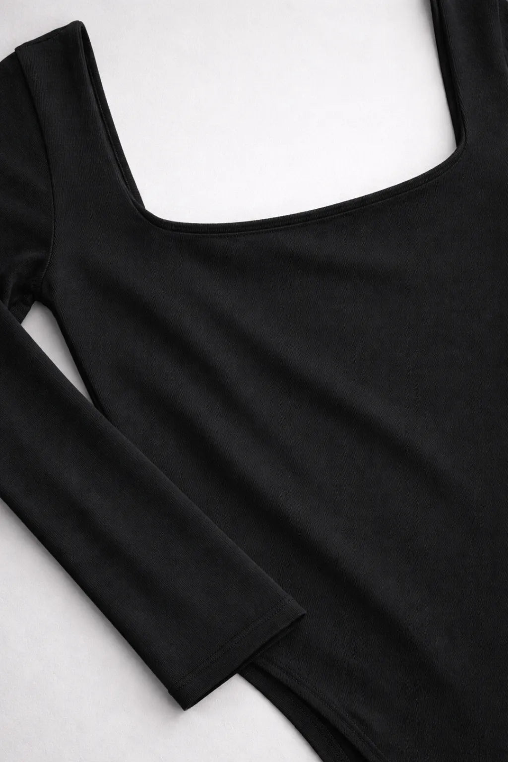 Black long-sleeve top on a white background