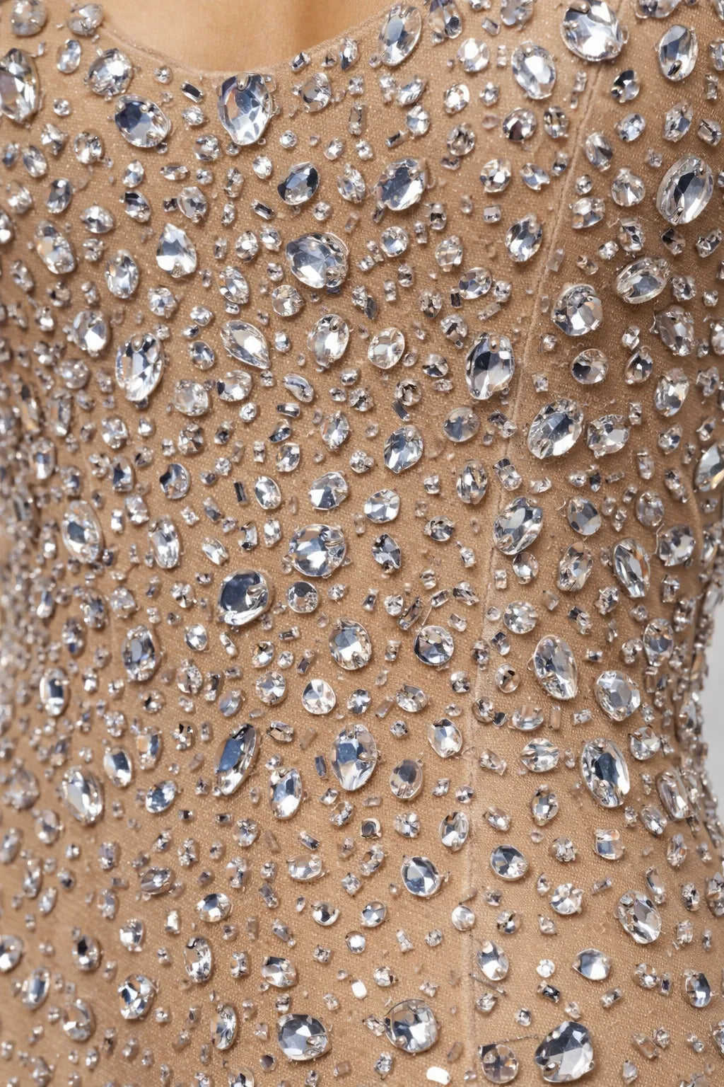 Close-up of a beige fabric with silver rhinestone embellishments