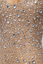 Close-up of a beige fabric with silver rhinestone embellishments