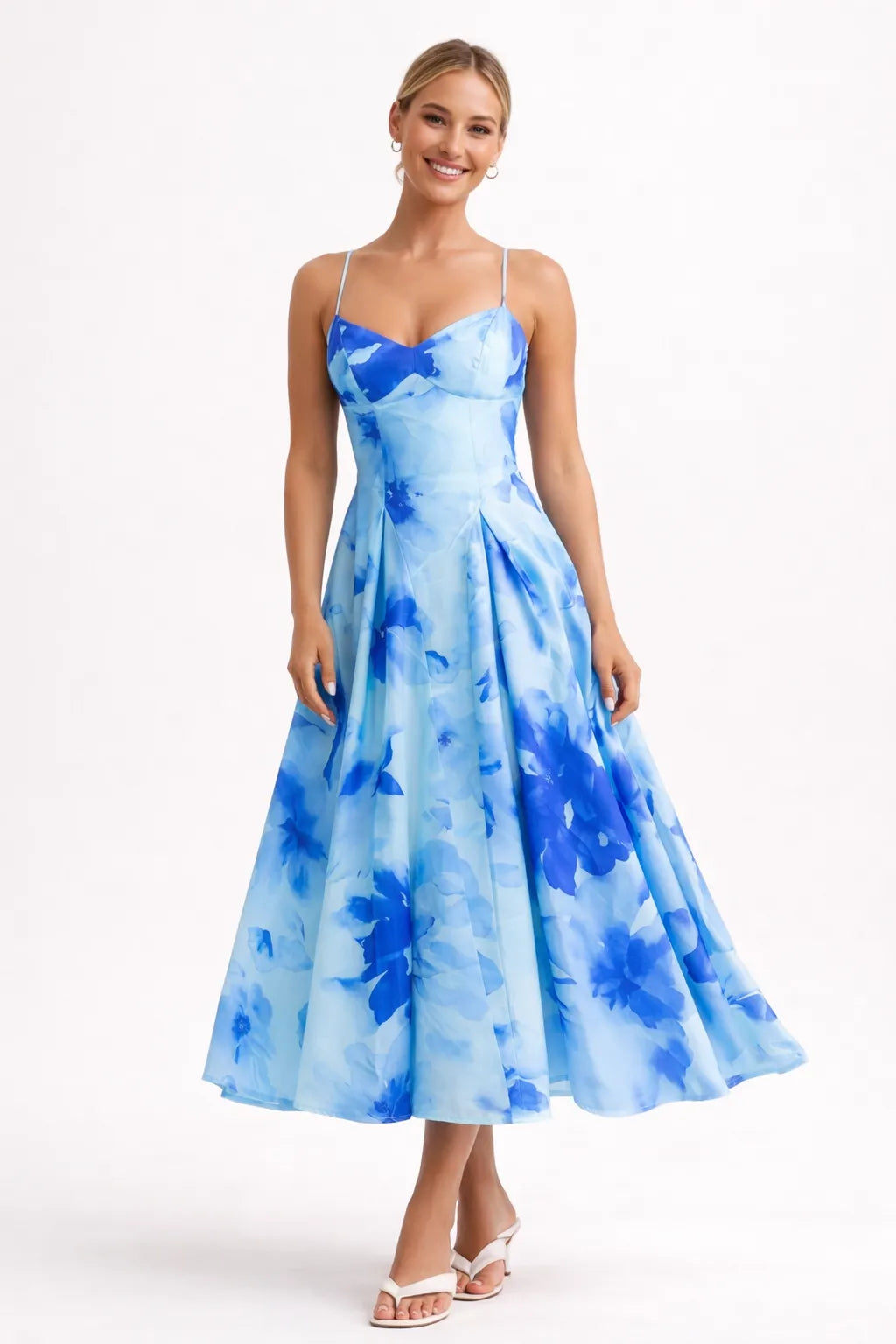 Woman wearing a blue floral dress on a white background