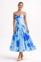 Woman wearing a blue floral dress on a white background