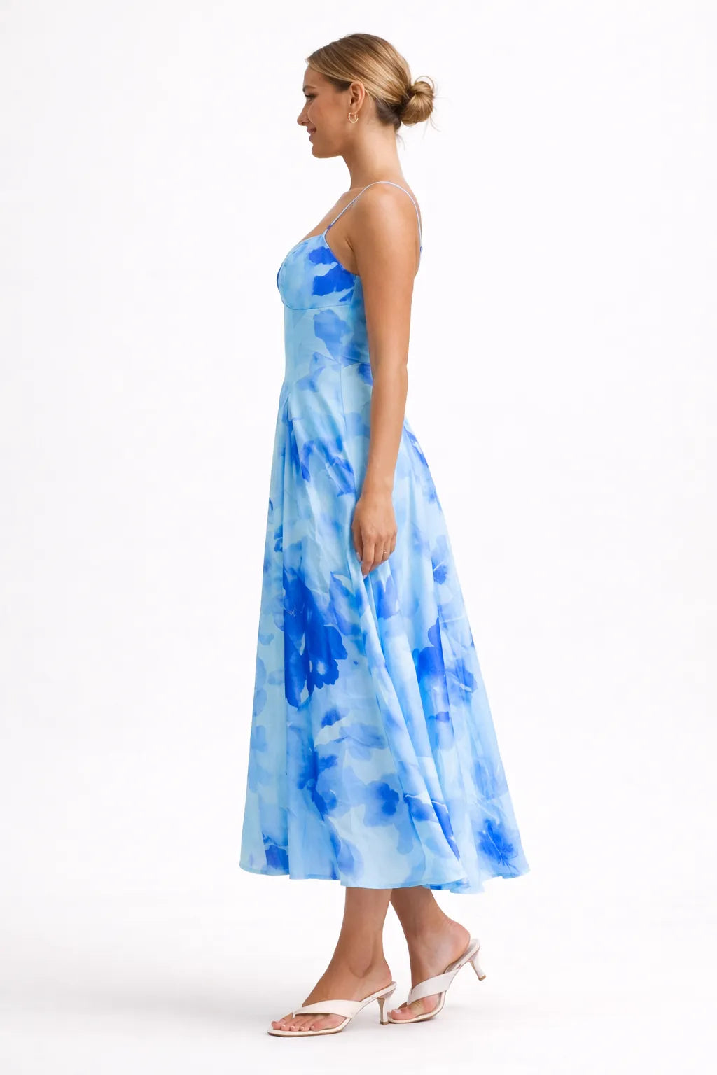 Woman wearing a blue tie-dye dress on a white background